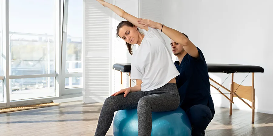 Therapist helping patient to stretch