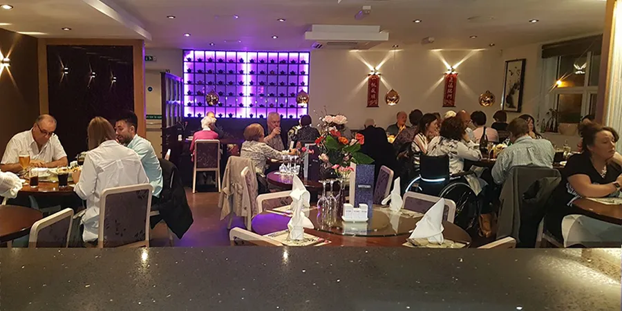 Photo of customers enjoying food inside the restaurant.