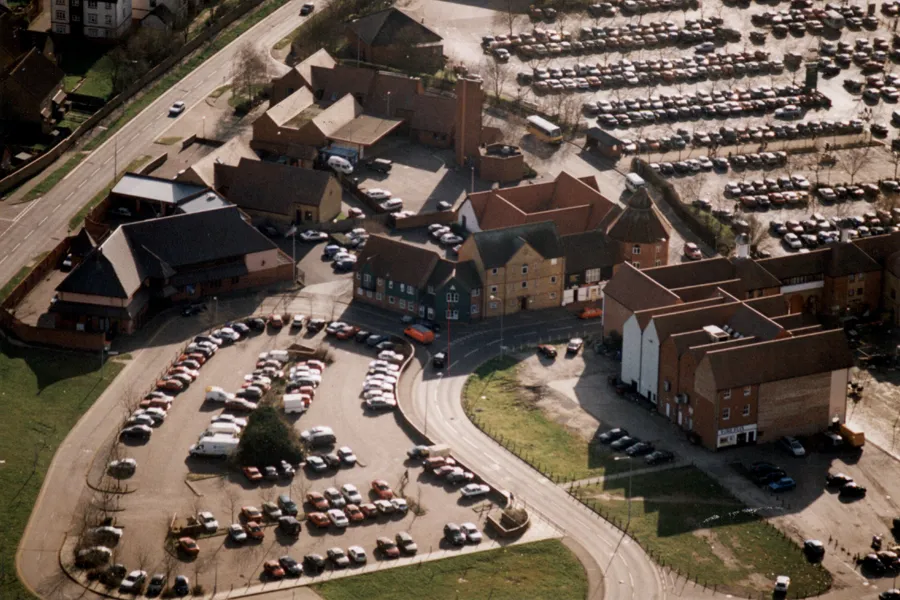 The aerial photo shows Woodham at a time when the Health Clinic, Greenwood Surgery and Brickfields Surgery had been completed