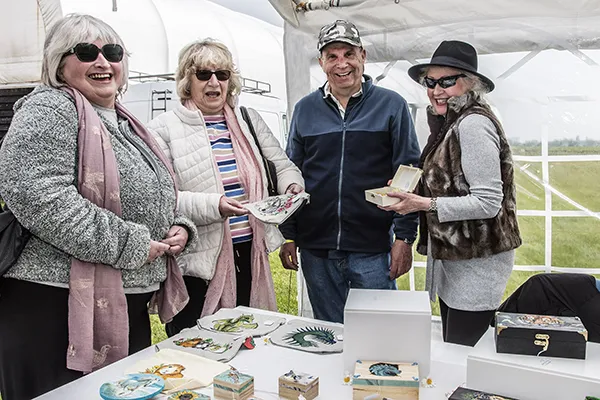 Tina and Linda check out the wooden boxs made by Murray and Dawn from Wolfangel crafts