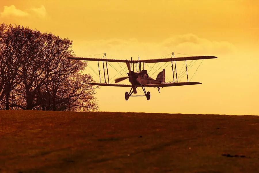 Bi-Plane landing at sun down