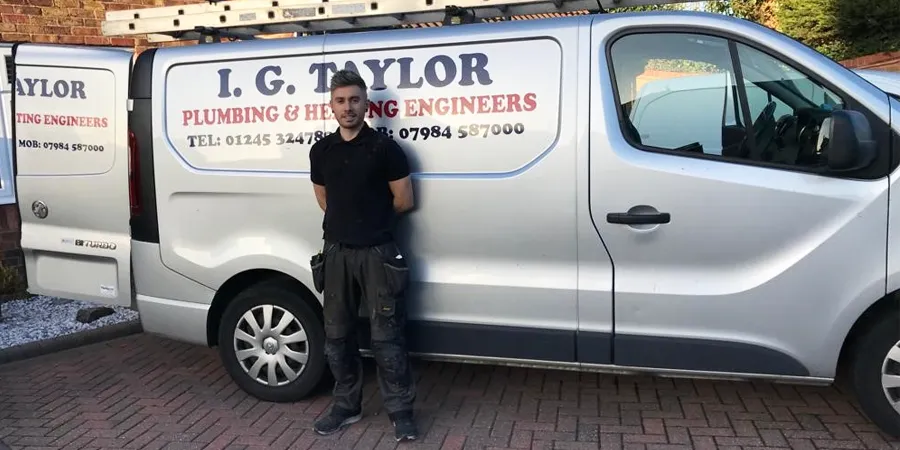 Nick standing beside the I G Taylor work van
