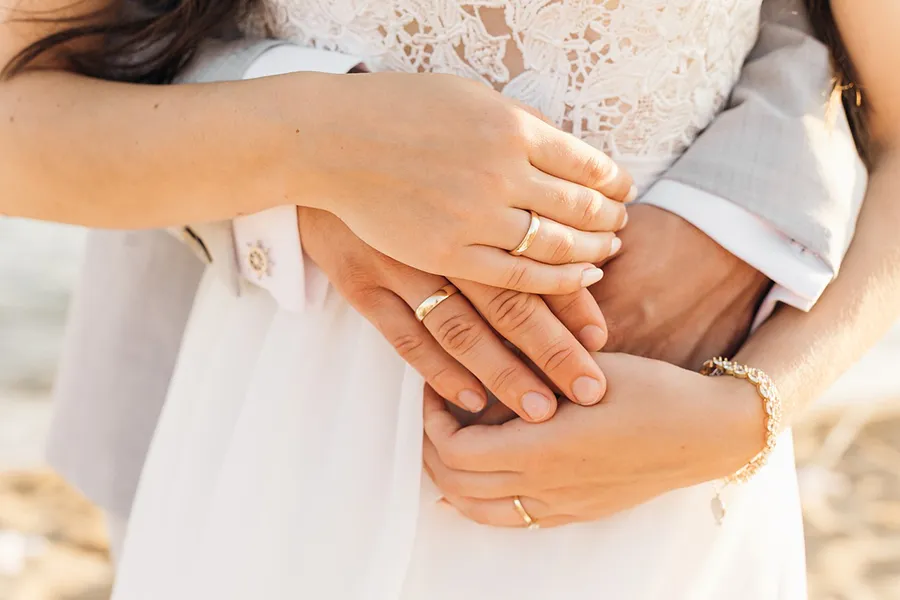 Hands of a married couple showing their wedding rings