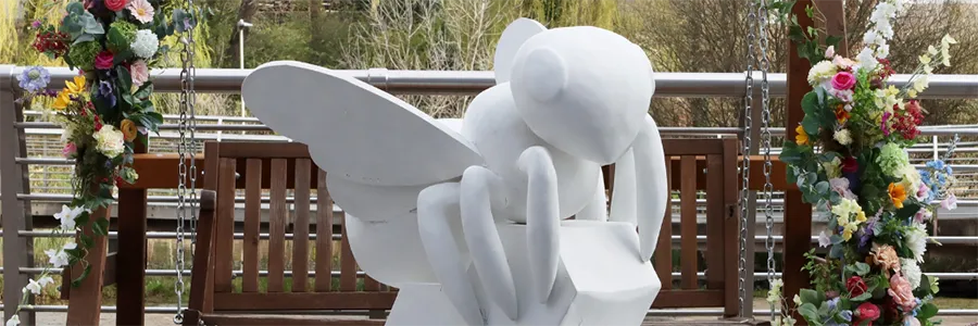 giant unpainted bee sculpture