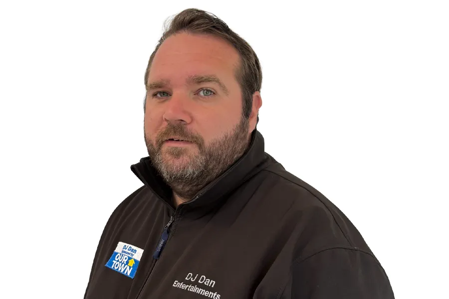 Photo of DJ Dan wearing 'Our Town' branding jumper.