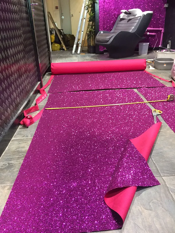 Cutting purple glittering wallpaper to size