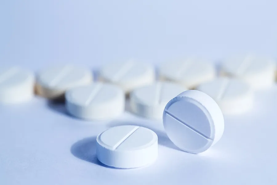 paracetamol tablets on a light blue surface