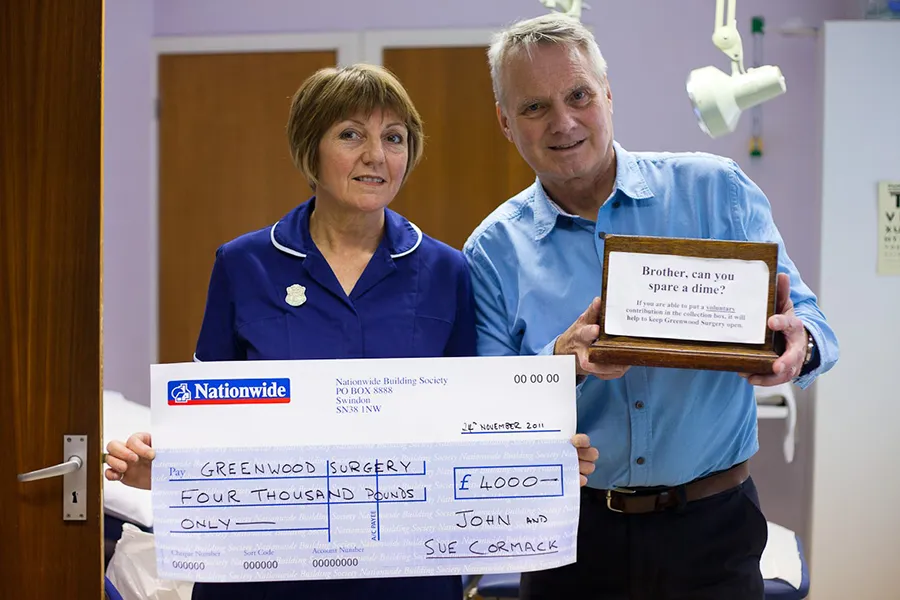 Sue and John Cormack with cheque.