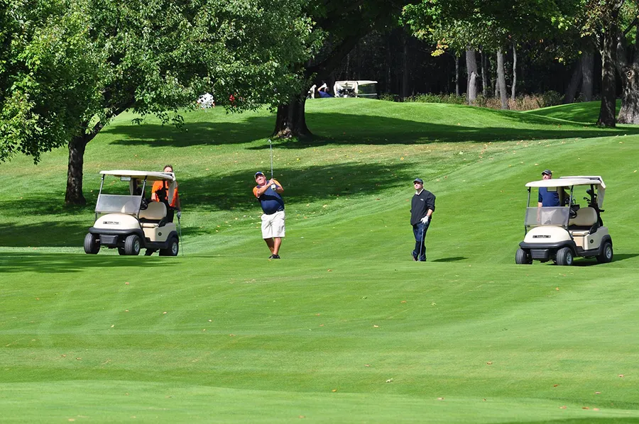 Four men playing golf