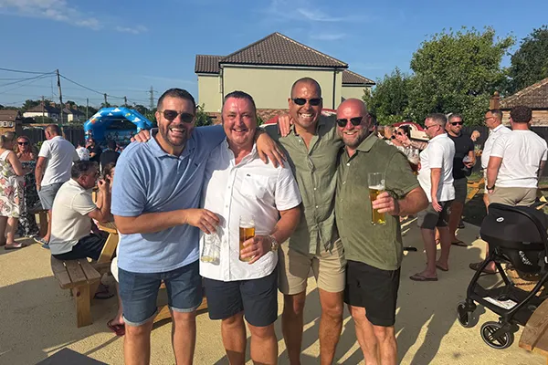Group of friends enjoying sunshine and drinks at the Whalebone Inn.