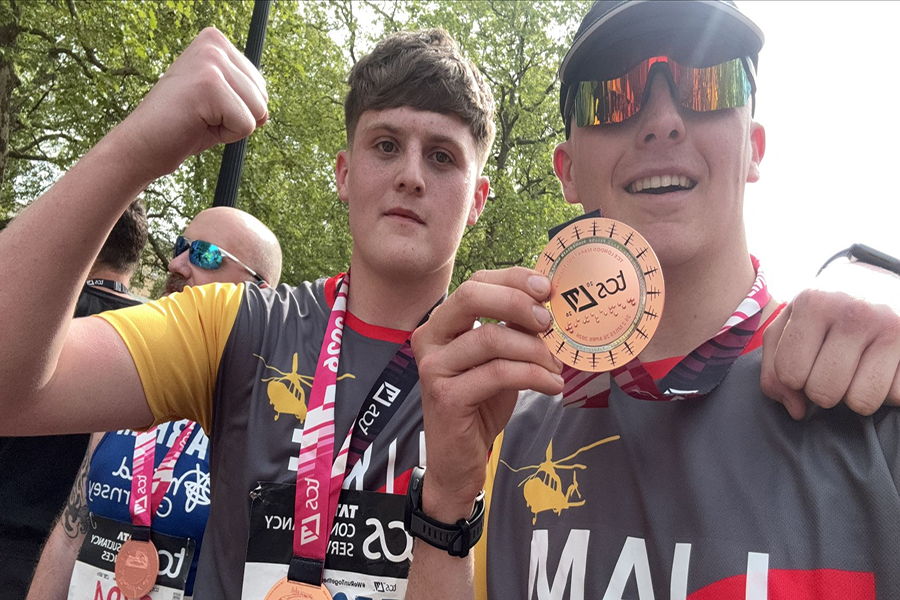 Holding up their medals