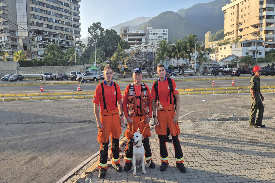 Three rescuers and their dog
